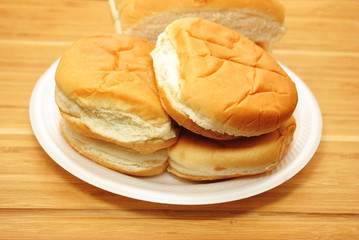Fresh Hamburg Buns Stacked on a White Plate 