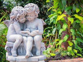 Fototapeta na wymiar Cupid sculpture in the garden.