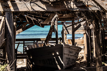 Formentera, Spain, 30 april, 2019 / Wooden fishing shack and boat on the beach in Formentera island, Spain