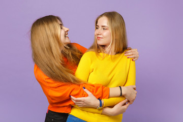 Two pretty young blonde twins sisters girls in vivid colorful cl