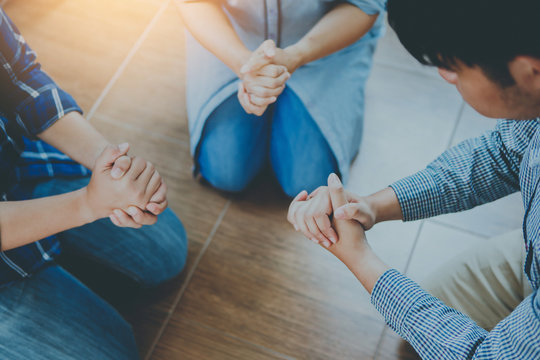 Three Christian Friends Knee Down  On Floor And Prays To God  Together Indoor, Small Group Fellowship And Prays Meeting Concept.