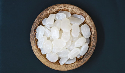 Sugar palm fruit on wooden plate on black background.