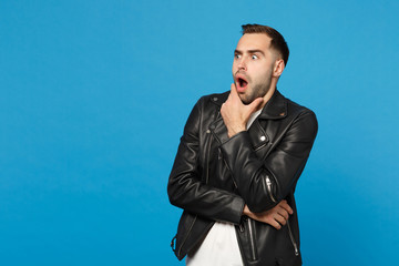 Young sad frustrated worried unshaven man in black jacket white t-shirt looking aside isolated on...