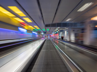 Fototapeta na wymiar Long Exposure moving walkway with neon light at underground