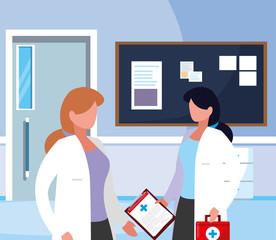 female medicine workers in hospital corridor