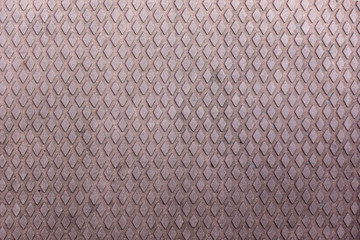 Rusty metal plate with diamond shapes protruding