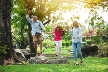 Happy grandfather, grandmother with granddaughter playing in summer day, Family relaxing in the...