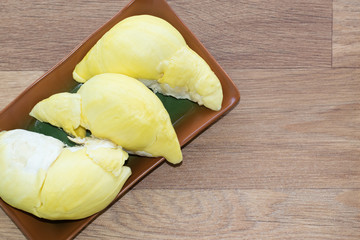 fresh Monthong durian on brown wooden background, Tropical seasonal fruit, King of fruit from Thailand.