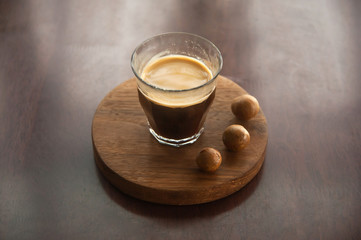 A cup of coffee with macadamia nut.