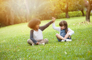 Children playing in the garden in summer day