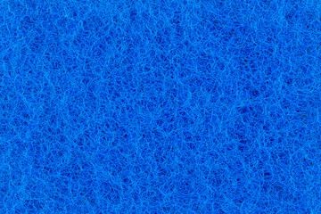 Fototapeta na wymiar Abstract texture of the blue surface washcloths for washing dishes macro close-up background