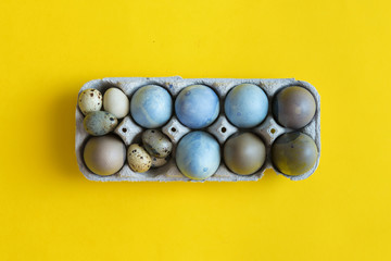 Blue Easter egg on yellow pastel background. Happy Easter concept Organic coloring hibiskus © troyanphoto