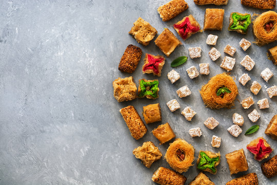 Traditional Turkish dessert baklava. Eastern sweets on a gray rustic background. Top view. Place for your text.