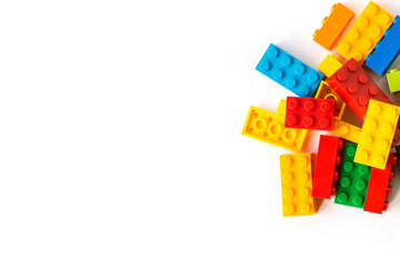 Bunch of many Colorful Plastick constructor bricks on white background. Popular toys. Copyspace