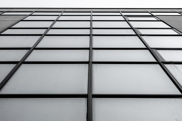empty windows of a gray high concrete building close up