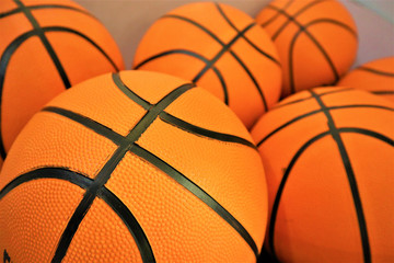 close up of a group of many new basketball orange balls