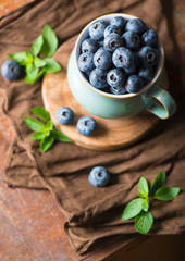 blueberry in a cup on a wooden background