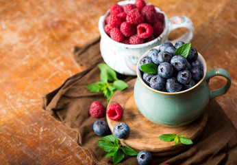 blueberries and raspberries on a wooden background