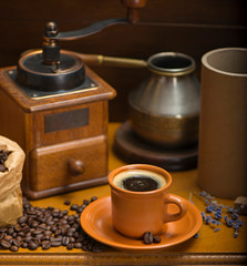 cup of coffee, turka, coffee beans and a coffee grinder, croissants