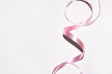 Pink curly ribbon isolated on white