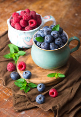 blueberries and raspberries on a wooden background