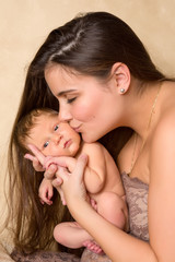 Mother kissing newborn baby