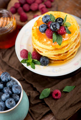 Stack of pancakes with fresh berries, close-up.