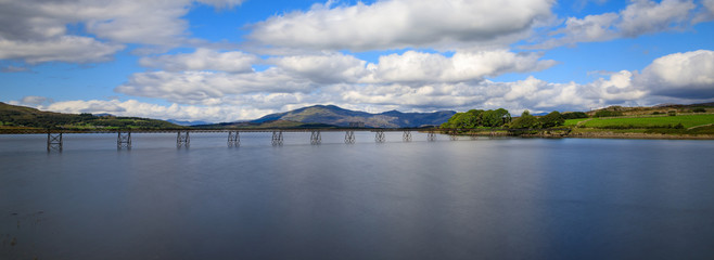 A long exposure of Trawsfynydd Lake in the south of Snowdonia, Wales, UK. Blue skies giving way, as clouds move in.