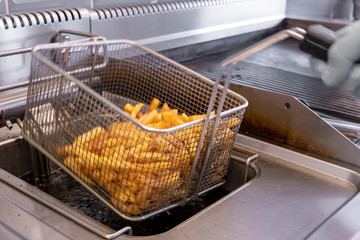 French fries prepared in hot oil in special metal grill