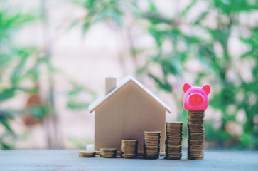 Small house add coin column The concept of saving money, investment properties