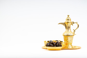 Fototapeta na wymiar Premium dates and arabic coffee set on white background. Selective focus, copy space and Ramadan Kareem concept