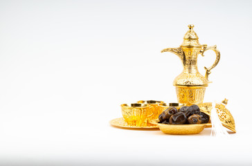 Fototapeta na wymiar Ramadan kareem with premium dates, lantern and arabic coffee mug on white background. Selective focus, copy space and Ramadan Kareem concept