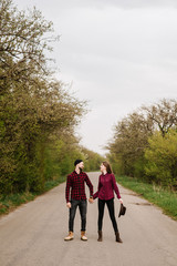 Fototapeta premium Happy active couple walking and have fun on the country side road