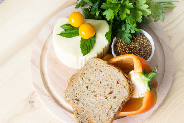 Suluguni cheese with vegetables and herbs. Georgian cheese with mustard, vegetables and rye bread.
