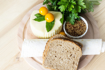 Suluguni cheese with vegetables and herbs. Georgian cheese with mustard, vegetables and rye bread.