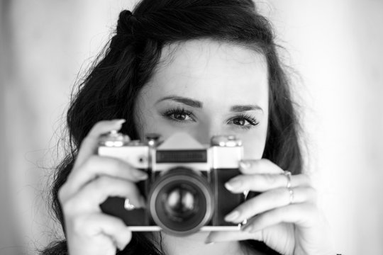 girl with a vintage camera. Photographer gaze.