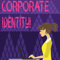 Writing note showing Corporate Identity. Business concept for firm or business presents themselves to the public photo of Young Busy Woman Sitting Side View and Working on her Laptop
