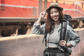 Naklejka premium Woman Traveler with backpack traveling on her summer vacation. Summer Holiday Travel Destination concept.