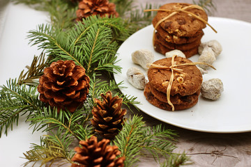 Christmas decorations - oat biscuits for Santa Claus and branches of coniferous trees