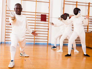 Sporty african american man fencer practicing effective fencing techniques