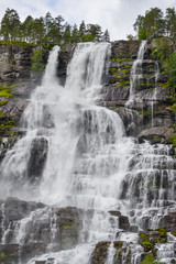 Obraz premium Tvindefossen Waterfall is a gorgeous 152m waterfall near Voss tumbling in strands with a graceful character. Tourism, popular, Norway, Scandinavia