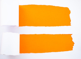 Torn white paper isolated on orange