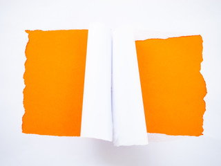 Torn white paper isolated on orange