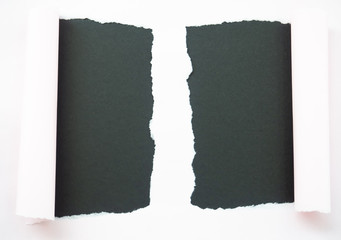 Torn white paper isolated on black