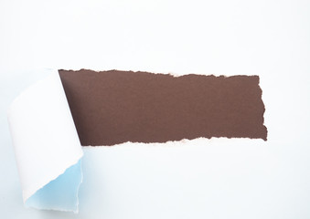 Torn pastel pastel blue paper isolated on brown