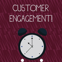 Writing note showing Customer Engagement. Business concept for the emotional connection between a customer and a brand Colorful Round Analog Two Bell Alarm Desk Clock with Seconds Hand photo