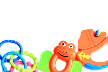 children's toys rattle in the form of a frog, a ship and chains on a white background, top view