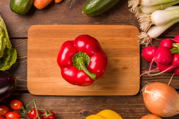 Sweet red pepper and other fresh vegetables and ingredients for cooking
