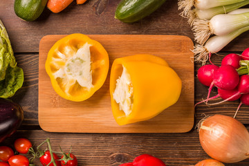 Sweet yellow pepper and other fresh vegetables and ingredients for cooking