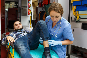 Paramedic team  providing first aid to man